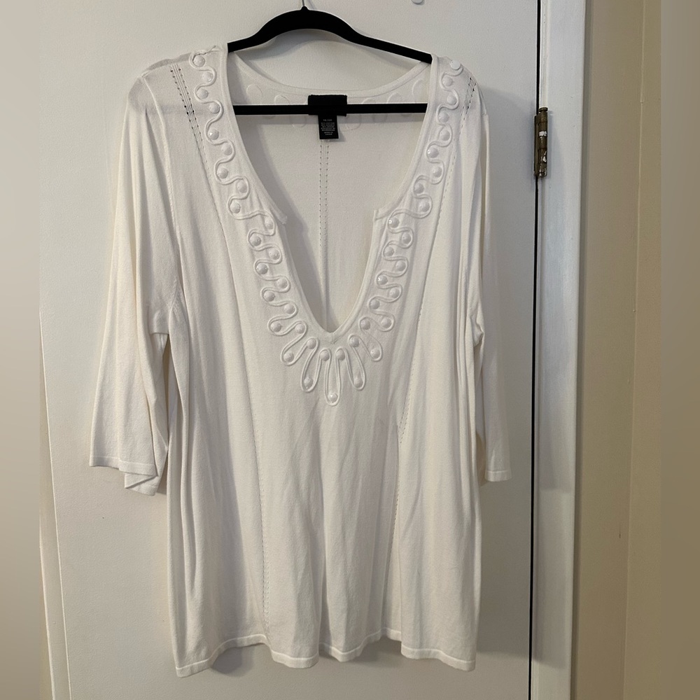 White sweater with pretty color detail.